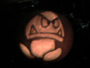 carved pumpkin with a goomba design from mario