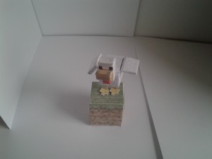 chicken papercraft model on a grass cutout block