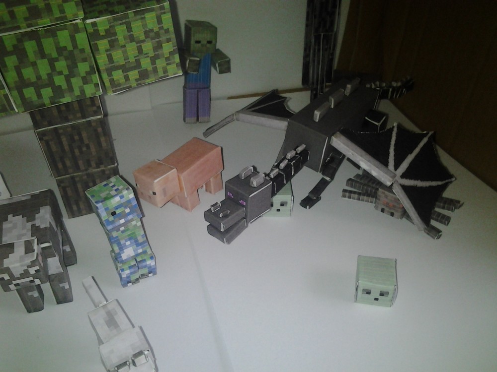 Minecraft papercraft model scene. Lots of animals, mobs and the enderdragon. Shows papercraft tree, papercraft wolf, papercraft ender dragon and more like the minecraft chicken, cow and pig from minecraft.