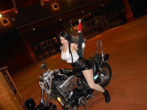 Tiffa Lockheart cosplay on back of a motorbike with the buster sword